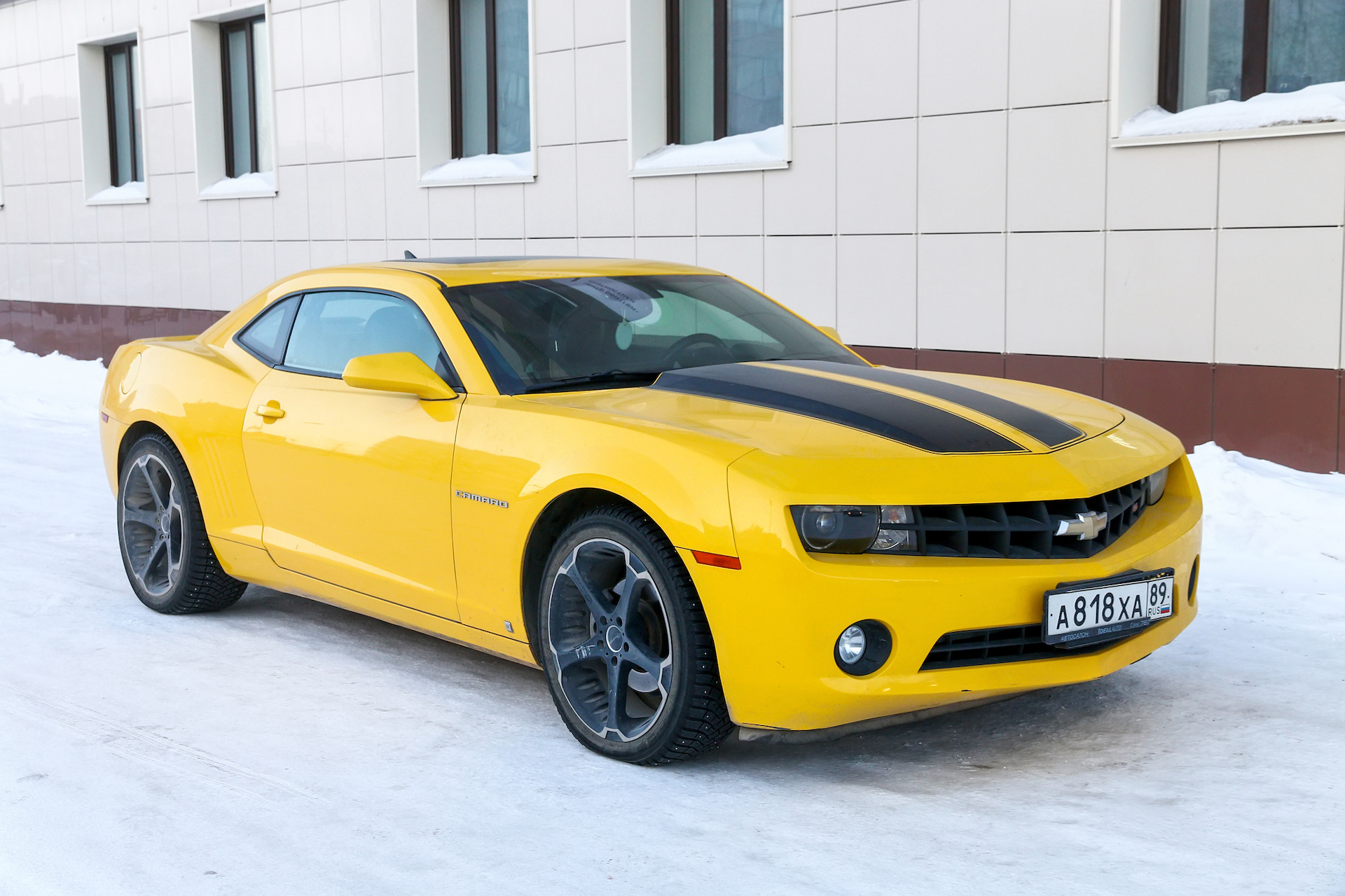 Novyy Urengoy, Russia - March 13, 2021: Yellow American muscle car Chevrolet Camaro V in the city street.